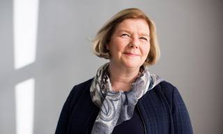 The President of Tampere University Mari Walls looks at the camera smiling.