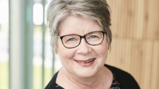 Dean of the Faculty of Education and Culture looks at the camera smiling.