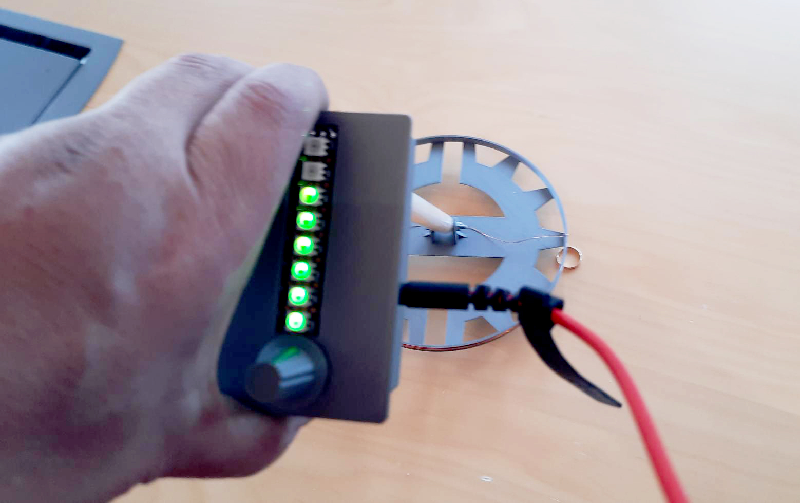 A photo of a treasure detector in hand.