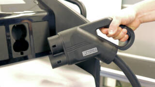 Electric vehicle charging cable with hand