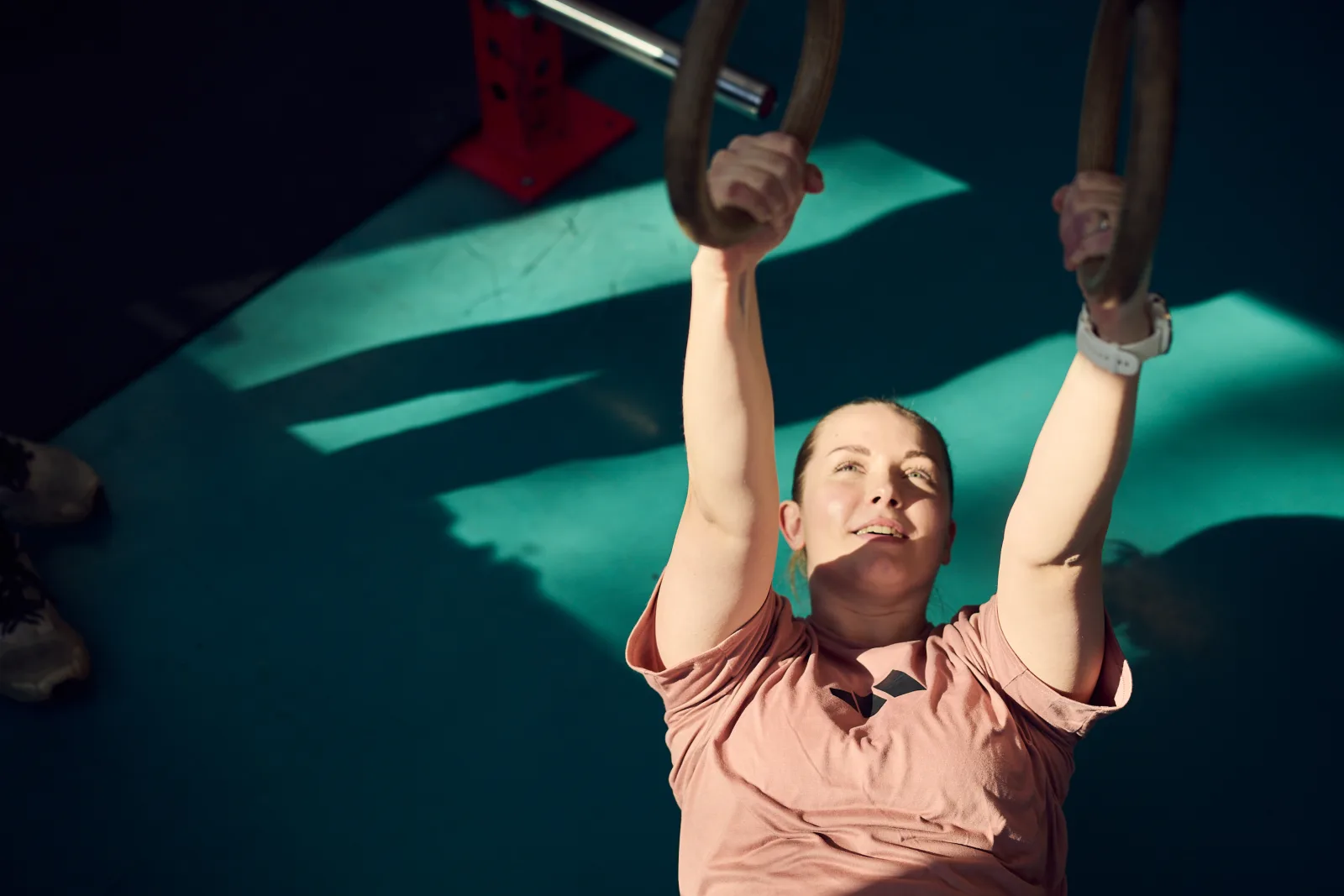 Student hanging in rings.
