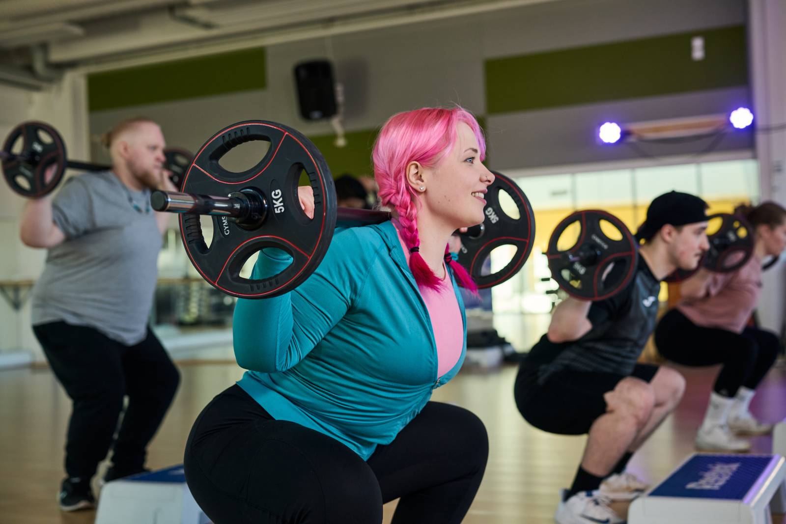 Female student is doing squat.