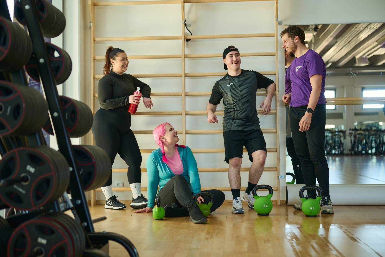 Student in group exercise room standing.