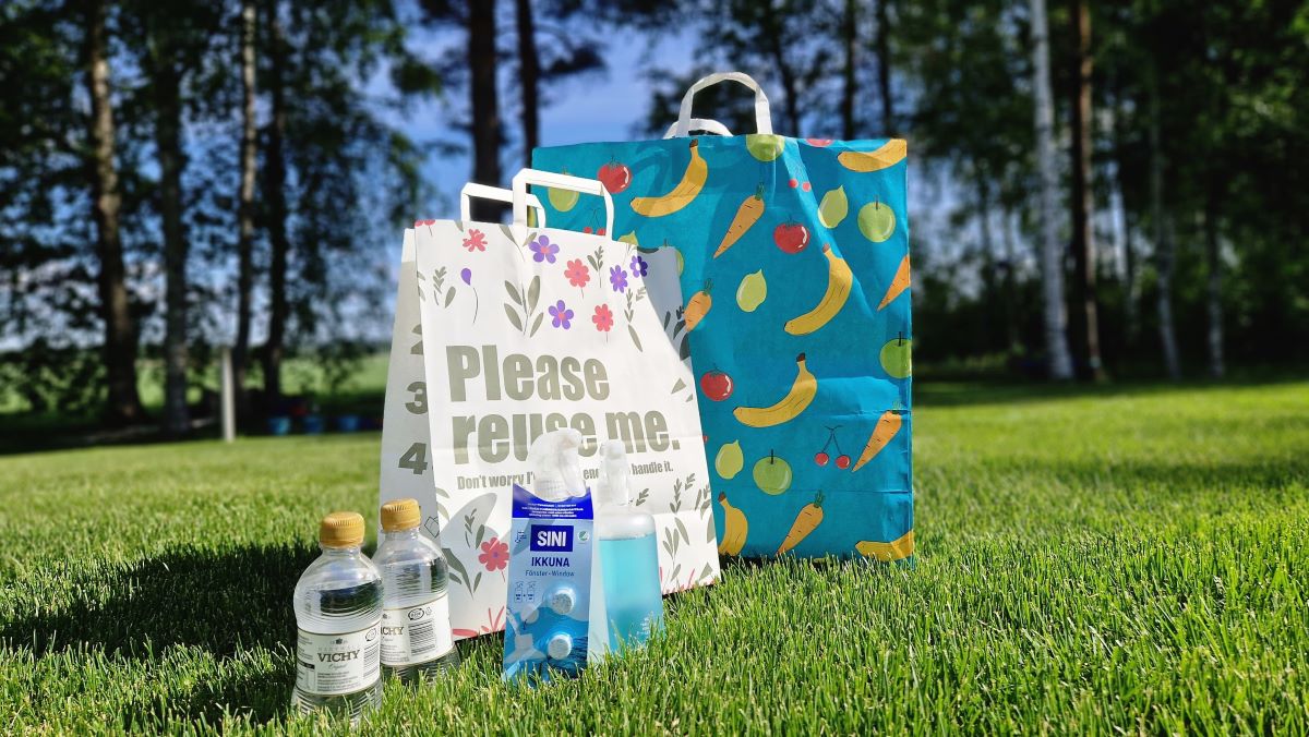 Circular packaging solutions used in a focus group discussion: Palpa deposit beverage bottle (PET), a refillable 0.5-litre spray bottle accompanied by two tablets and fiber based reusable shopping bags.