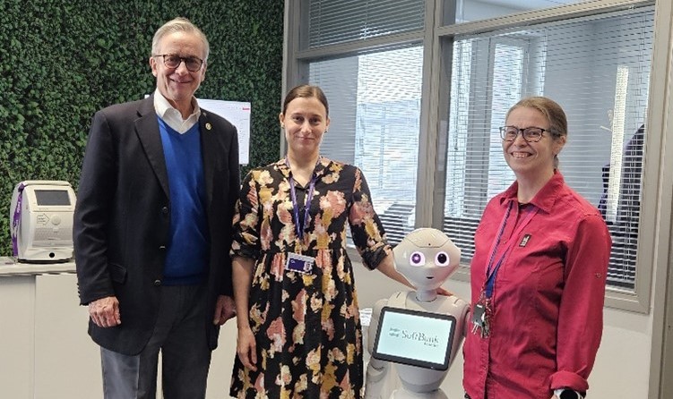 In the picture: Peter McMenamin, Marjo Tienari, Pepper robot, and Pipsa Tuominen. The photo was taken by Lea Saarni