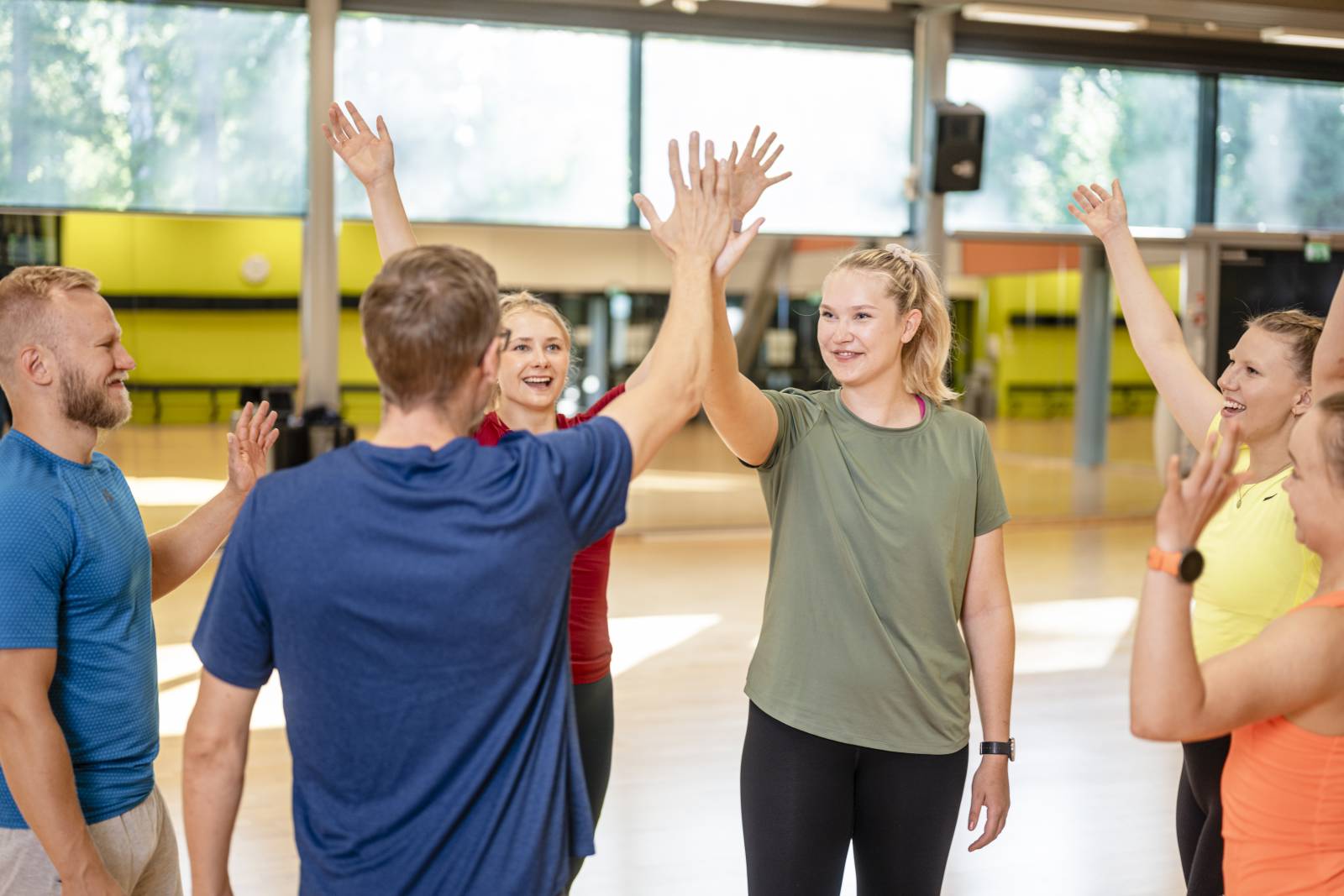 Students give high fives indoors